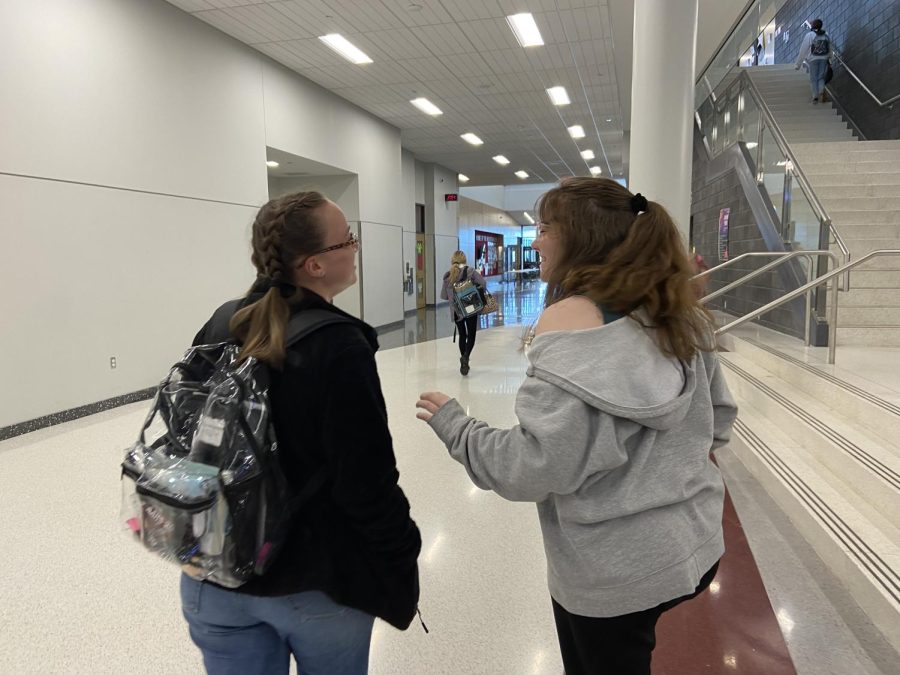 As seniors Destiny Montgomery and Madison Zimmerer walk out of the building, they share stories about their day. Montgomery and Zimmerer have the title of Editor in Chief for their publication.