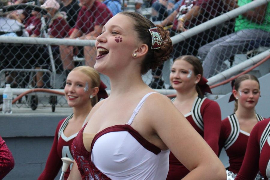 Team caption. Senior Danielle Bardelang leads her majorette team for the game. Bardalang has been twirling since nine years old.