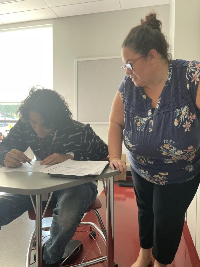 Helping hands. Jennifer Cala helps students during a test in their geometry class. Cala loves working with the students and helping them in any way she can. 