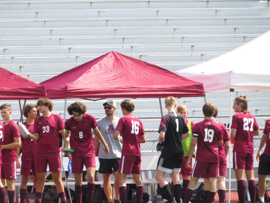 Huddle up. The boys soccer team takes a quick break as they prepare to resume their game. 