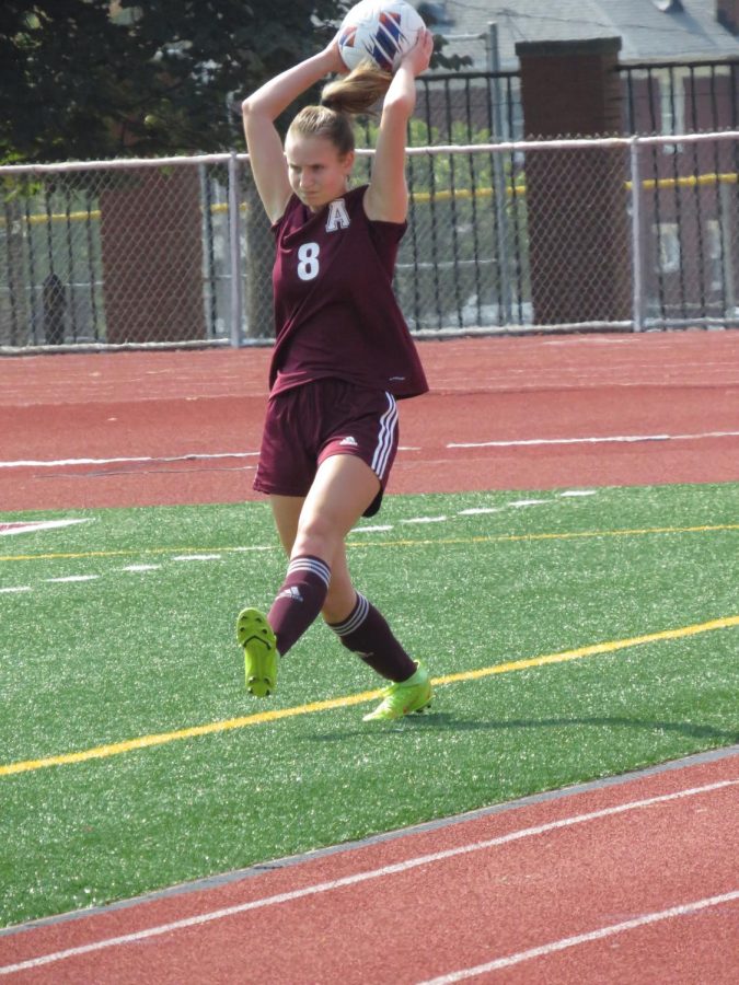 Sophomore Lia Sankey throws the ball back into the game. Lia has been playing soccer for 11 years. 