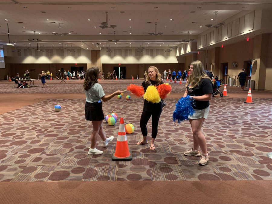 Orange, yellow, and blue. Attendees of the Autism Awareness Walk stroll around the second floor of the Convention Center. The Autism Community distributed pom-poms in various colors to the participants.