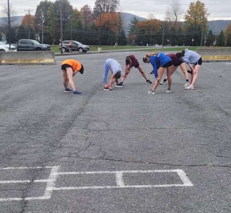 The Altoona Lady Lions stretch as a team. The team practiced at their District course.