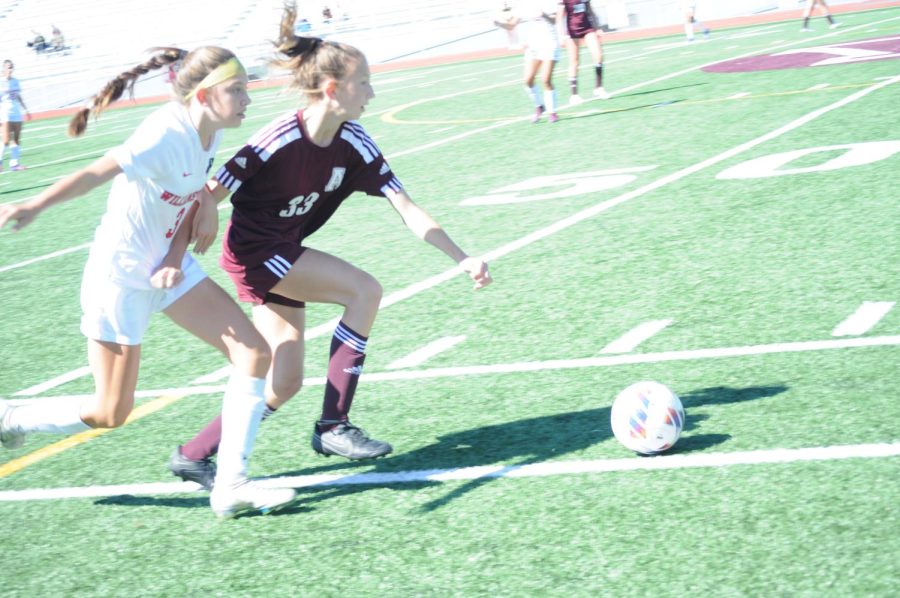 Chasing the ball. Freshman Sophia ODea is running hard to keep control of the ball. 