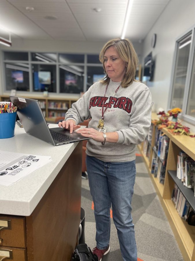 All in a days work. AP and honors English teacher, Jennifer Lowe doesnt stop. Not even for a picture of her Guilford college hoodie. 