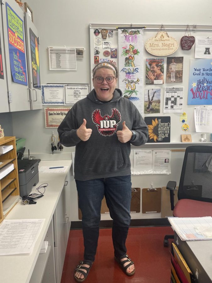 Thumbs up. History teacher McKenzie Negri shows off her IUP hoodie before jumping back into work. 