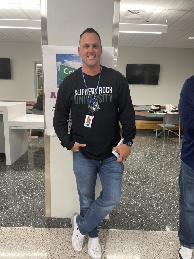 Surprise photoshoot. Assistant principal Jason McGinnis takes a break during his busy day to sport his Slippery Rock University sweatshirt. 