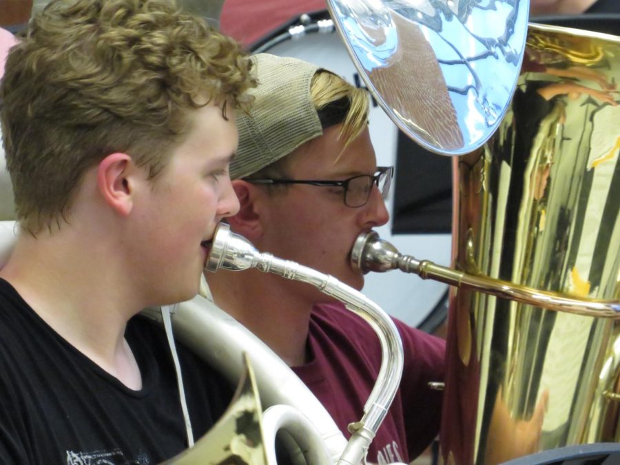 In sync. Senior Jacob Steinbugl and sophomore Seth Goheen play along to the song You Give Love a Bad Name. Steinbugl and Goheen both play sousaphone. 
