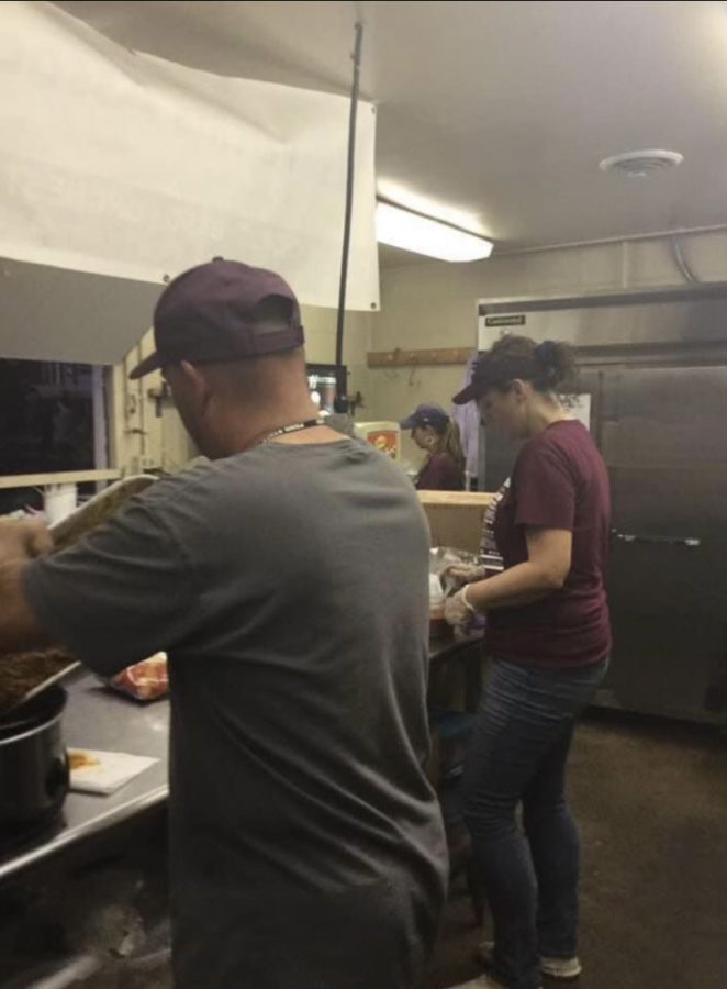 Jeremy and Jenn McCauley are busy working at the taco station which prepares walking tacos, nachos with cheese or buffalo chicken dip and chili cheese dogs during football games.