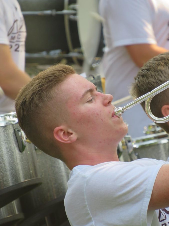 Playing along. Sophomore Blake Riddle plays his trumpet along with the band. 