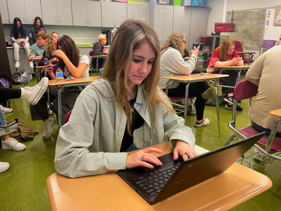 Due diligence. Sophomore Ava Cabell finishes her homework during a club meeting. It is important for students to use time wisely and use any opportunity to get work done.