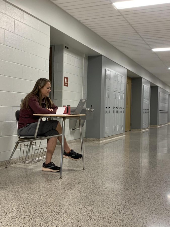 Hall duty Sitting at her desk, physical education teacher Megan Yingling enjoys the silence of the hallways compared to the loudness of her gym classes. Yingling used her time in the hallways to update grades for the first marking period. 
