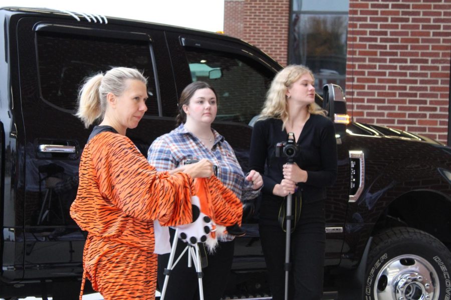 Photo Booth Horseshoe Yearbook and Mountain Echo adviser Wanda Vanish, senior Cassidy Klock and junior Makenzie Closson set up to take photos. The publication staffs handed out candy and took pictures of the families who came to trunk-or-treat together.