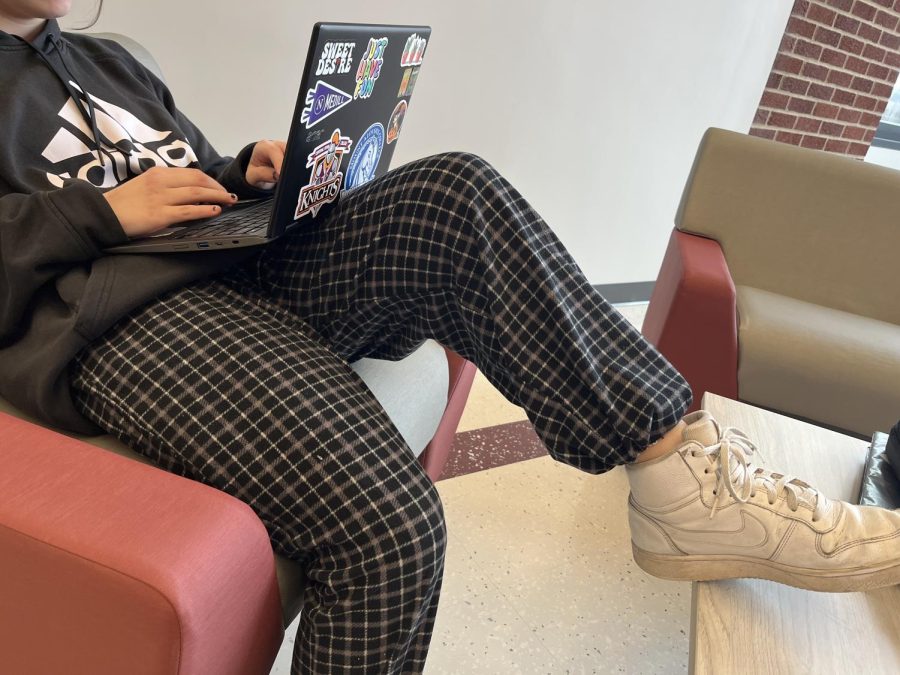 Laid back and relaxed. A students lounges in the student commons area to complete homework. Some have debated on whether or not pajamas should be allowed at school.