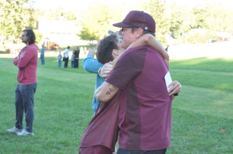 Celebration. Ryen Webster accepts a hug from his coach after finishing a race. Webster has been running for DAngelo for multiple years. 