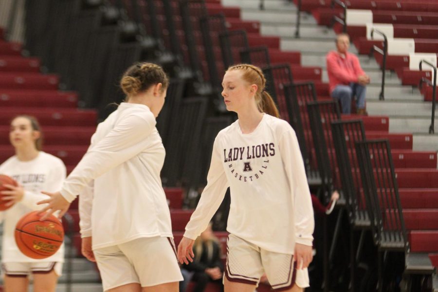 Getting Ready Junior Jersey Hollabaugh and freshman Kendall Cogan warm up pre-game.