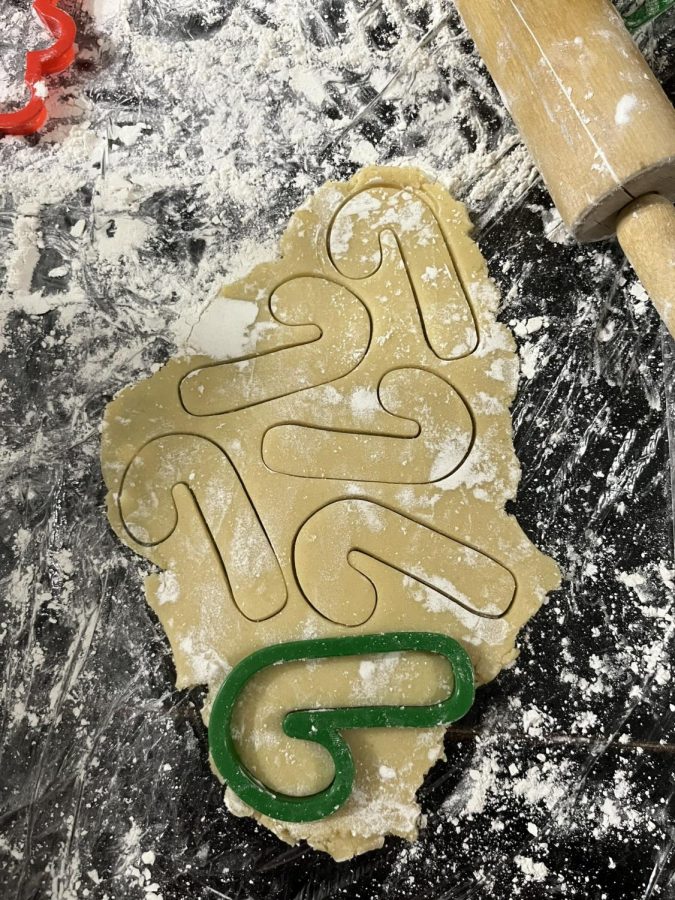 Candy canes! Candy cane shape sugar cookies are being made. The dough was rolled out with flour on it so it wasnt sticky when making the shape with a cookie cutter. 