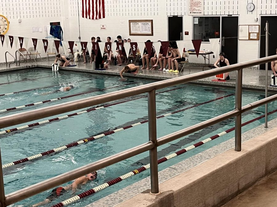 Almost there. The 5,000 yard race consists of 20 laps, down being one and back being two. The swim team has boards they can put into the water to show the swimmer what lap they are on, they also have different movements to tell the swimmer to go faster or slower. 