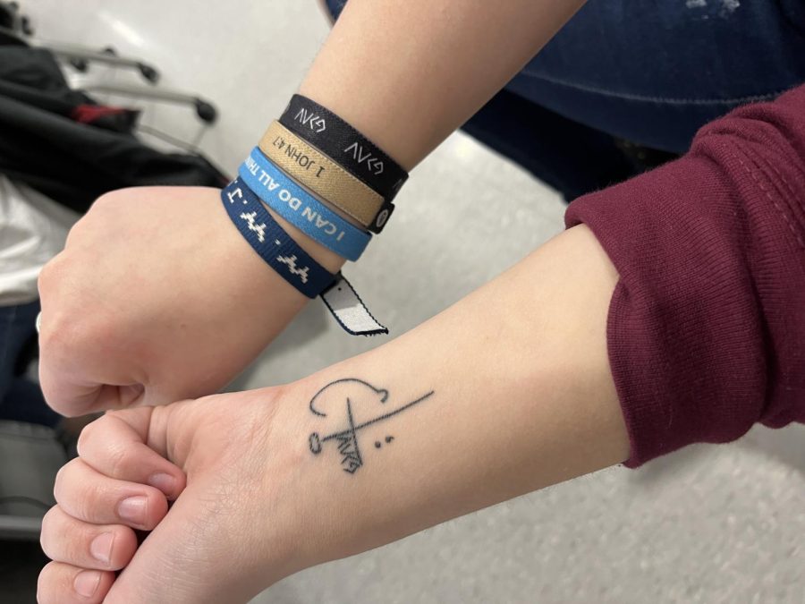 Openly faithful. Senior Danielle Bardelang shows off her faith based tattoo and bracelets. Although she will not force her faith on anyone, she is open about her faith.