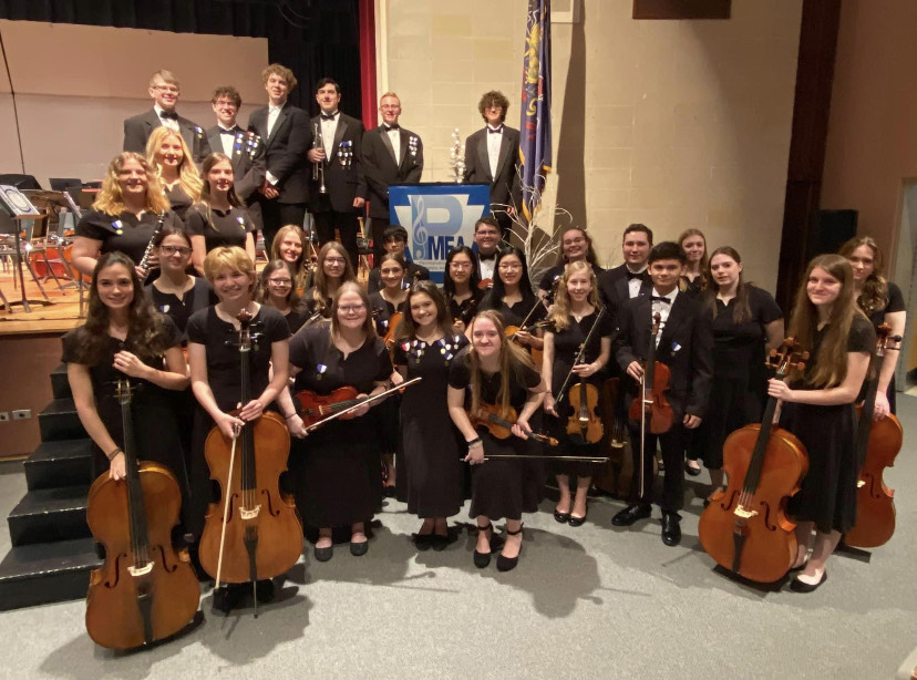 Its Time. The students who traveled to play in District orchestra pose to take a group photo. The photo was taken right before they performed for friends and family. 