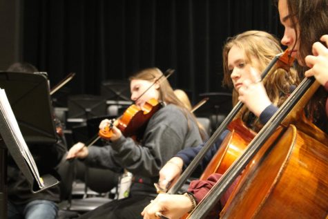 Practice time. The string ensemble practices their music.