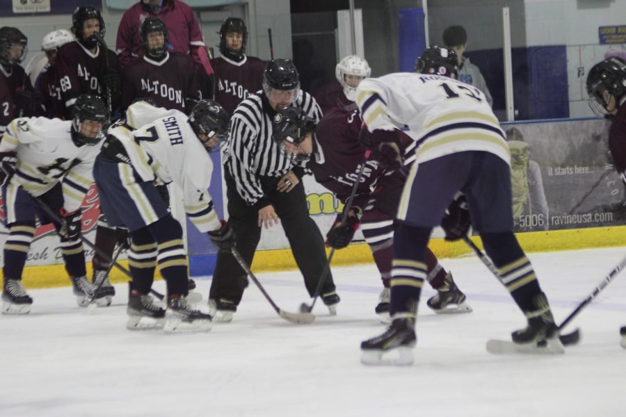 Get that puck! Altoona and Holidaysburg players face off. Altoona won the face off resulting in them getting possession of the puck. 
