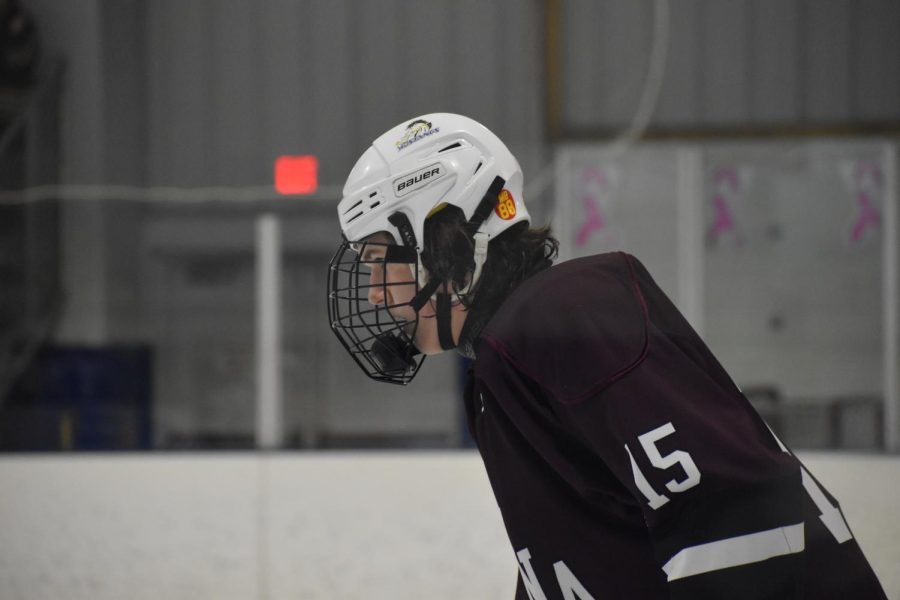 Game Face. Junior Garrett Rupert seeks through the other players to find the puck. Garrett kept his head in the game as the Hollidaysburg student section was chanting his name. 