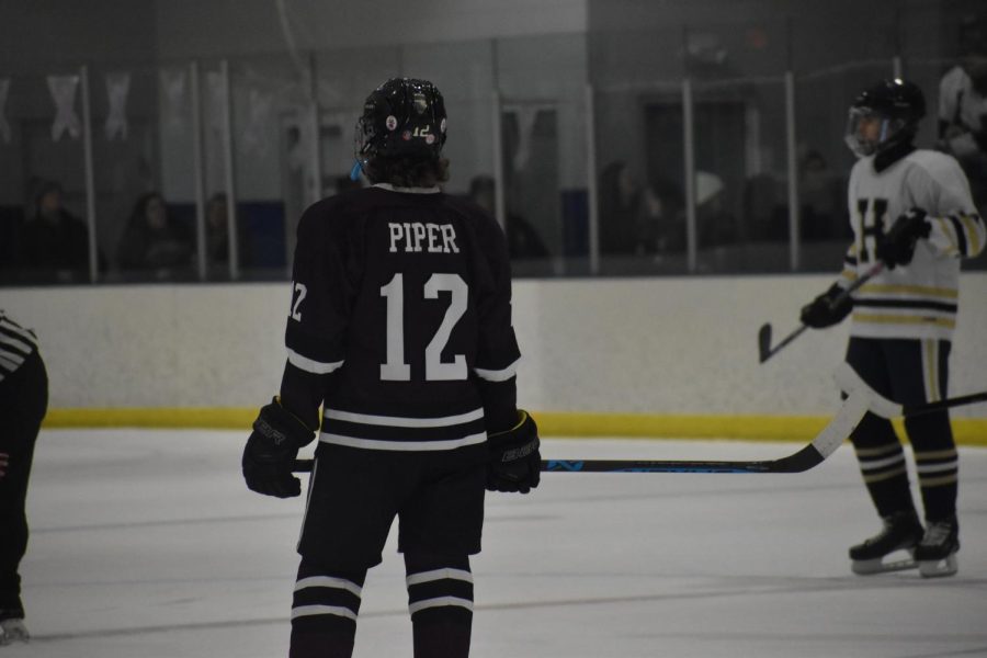 Whats happening. Freshman Owen Piper watches as the puck is passed between players. Piper is the only freshman from Altoona on the team. 