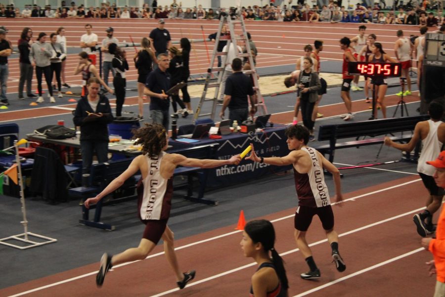 Hand Off Sophomore Justin Bossler hands off the relay baton to freshman Elijah Lucioin the 800m relay.