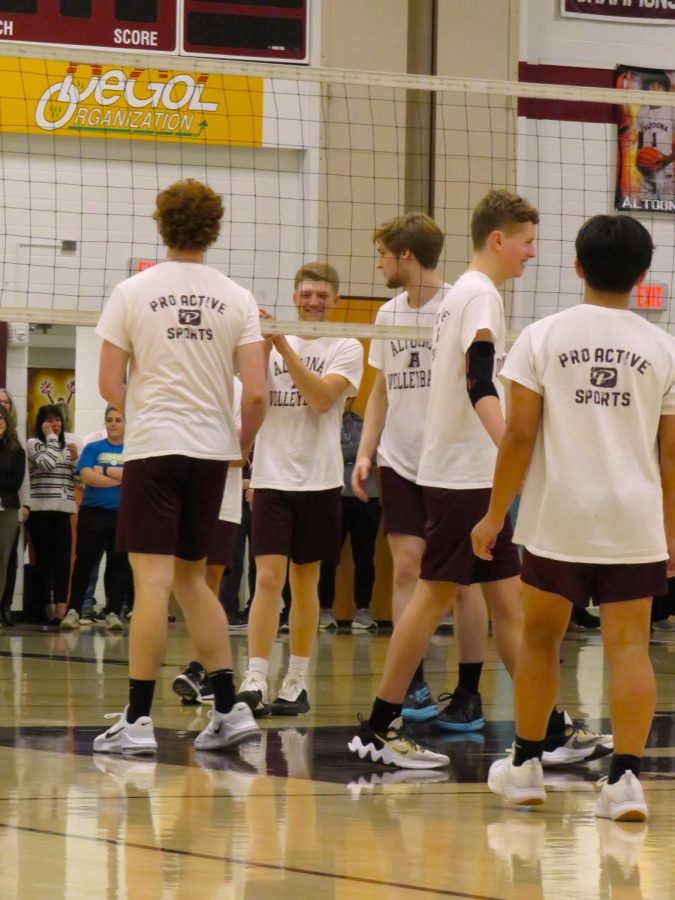 Making our plan. Members of the boys volleyball team group together before they start to figure out what to do to win. 
