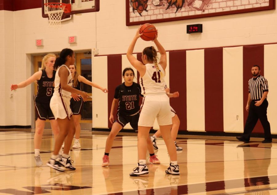 Freshman+Sam+Harpster+looks+for+someone+to+catch+her+pass.+The+girls+basketball+team+advanced+to+the+State+playoffs.+