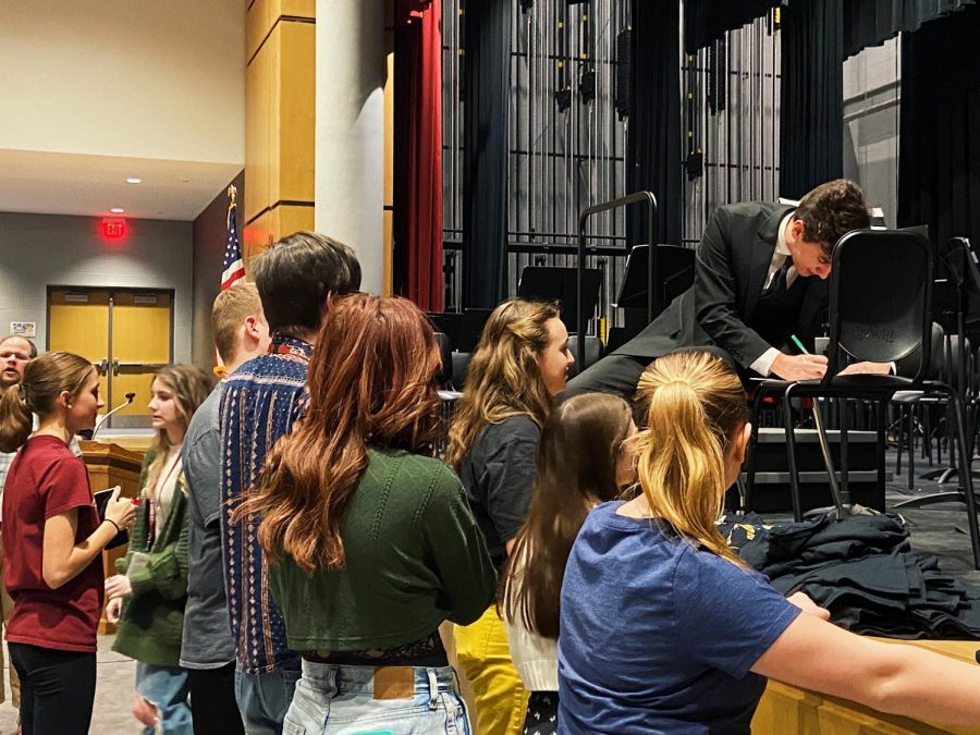 Senior Ben Kennedy helps distribute the drama clubs new t-shirts. The play this spring is 42nd Street.