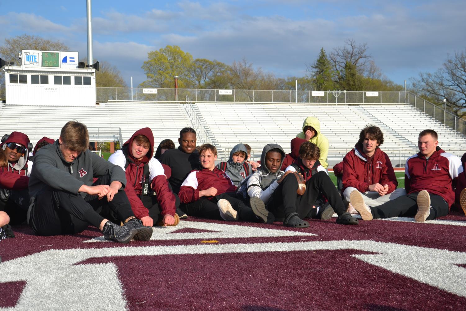 The track team has a meeting and is told they won after the Carlisle meet. 
