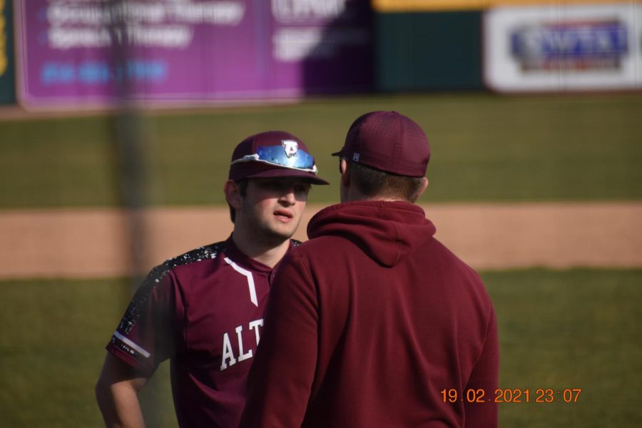 Father - Son Bonds. Senior Connor Weyandt discusses plays with his father and assistant coach Jerry Weyandt. Weyandt played as the second baseman. 