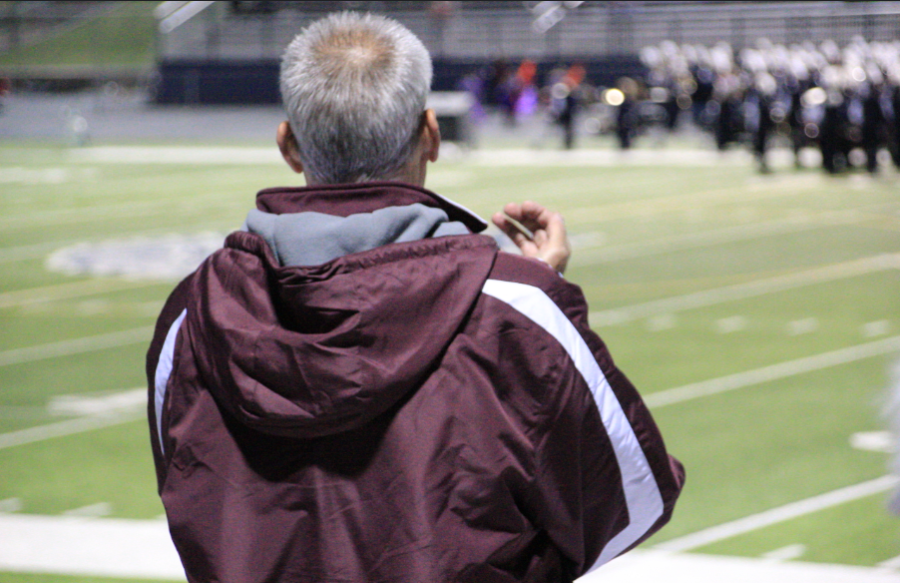Band director Larry Detwiler watches practice from the sidelines earlier in the year during football season.