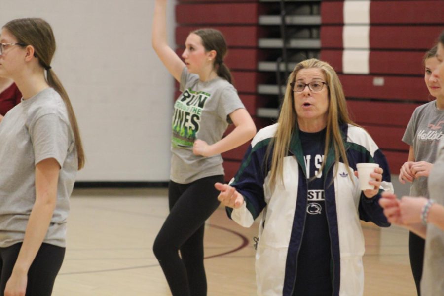 Stern Stance, Coach Julie Schmoke corrects a dancer after performing the Hey Song.  The dance is performed at every football game and is tradition for the Lioneers. 