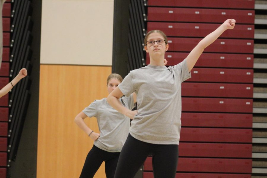 Freshman Savanah Coho  preforms the routine along with her teammates. Lioneers have a dress code for each practice. 