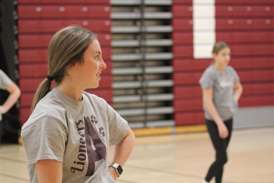 Junior Leiya Resig watches as her teammate explains the dance. The dances they practiced are in preparation for next year. 