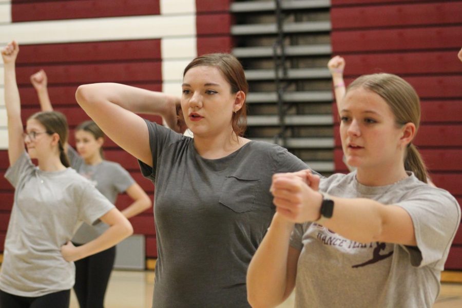 Tough moves, Sophomore Izzie Johnson learns the dance from older member, Mykynzee Milchak. Milchak and Johnson dace together at the same studio, Altona Dance Theater. 