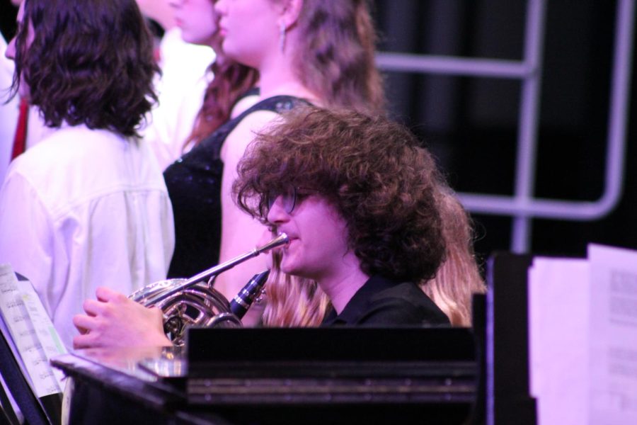 Accompanying Junior James Horrell plays during the chorus concert. He played the French horn and has played it since junior high.