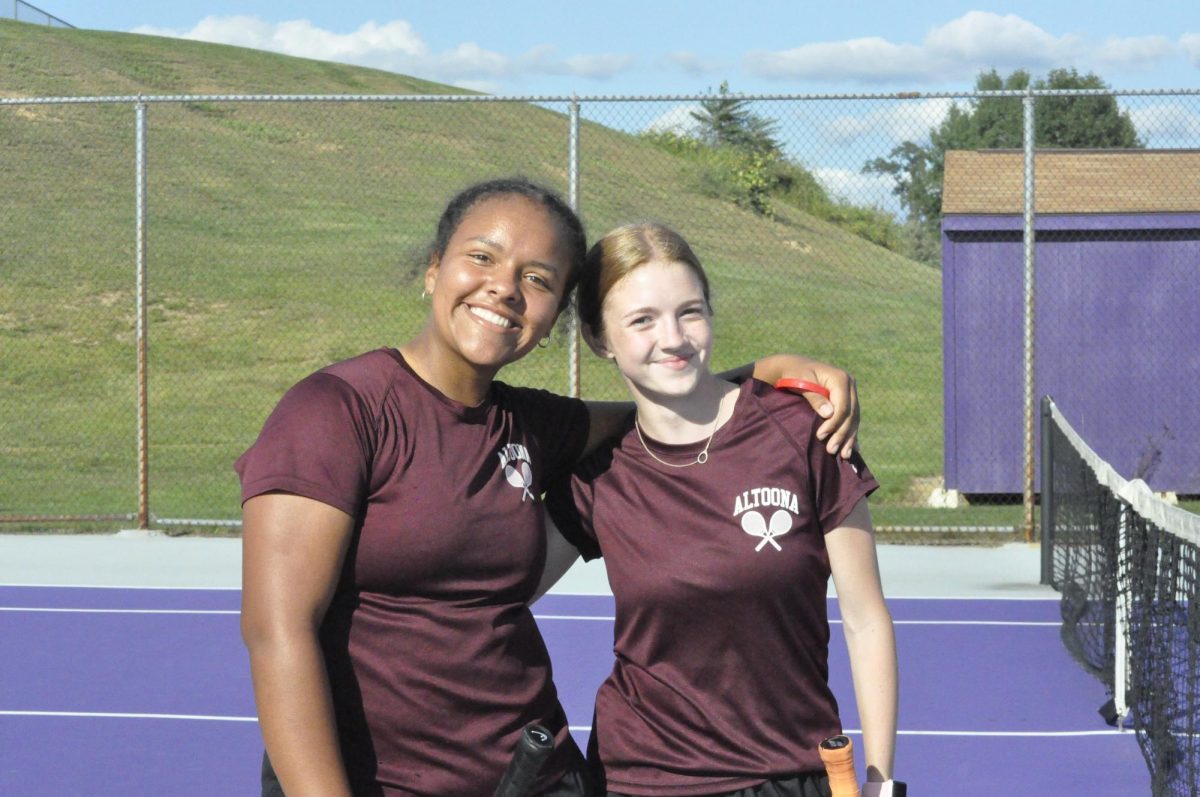 Dynamic Duo. Juniors Courtney Irwin and Isabella Graham smile for a photo directly after winning their match against Mifflin County. The two practice and prepare to team up in the district doubles competition. 