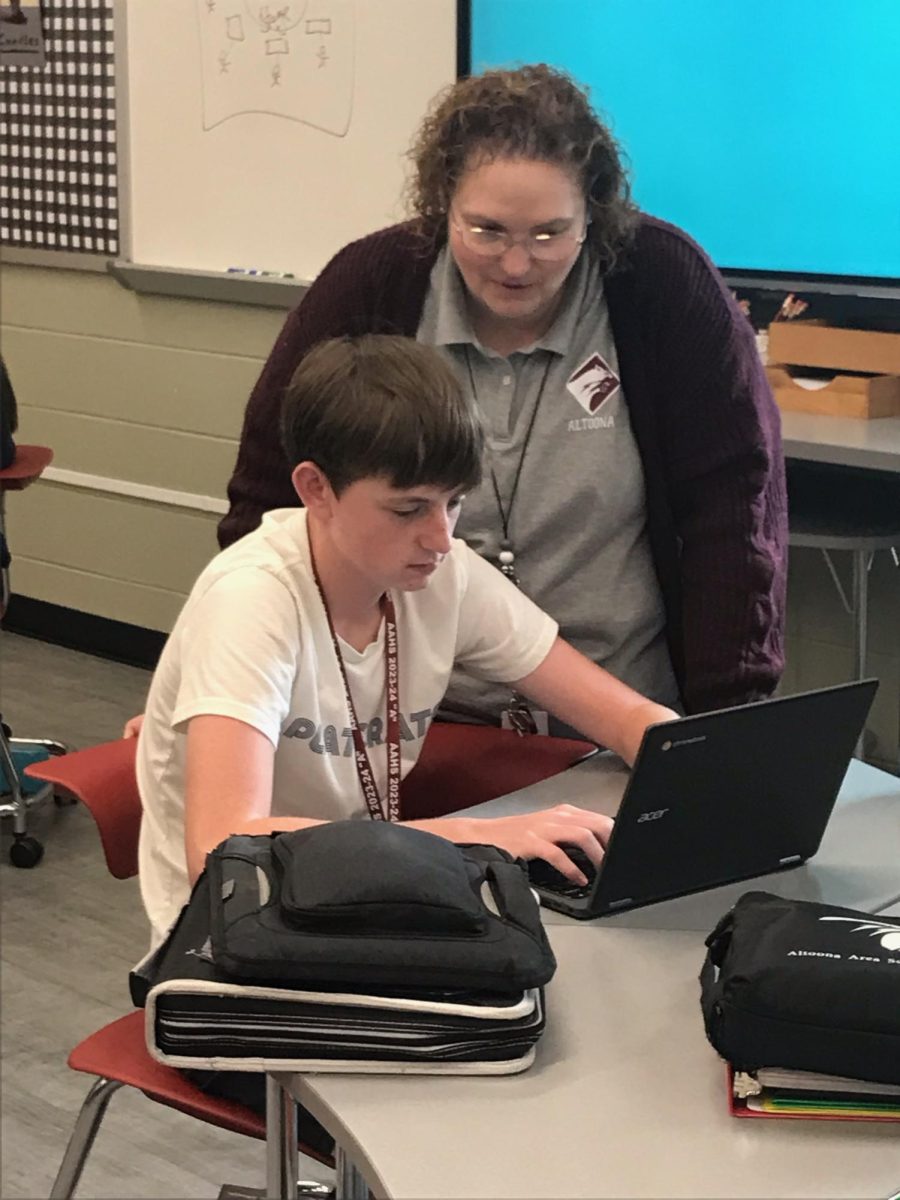 A Helping Hand.  Betsy Cron helps sophomore Ethan Akins with his assignment. The kids had some down time after she explained the steps to do it.
