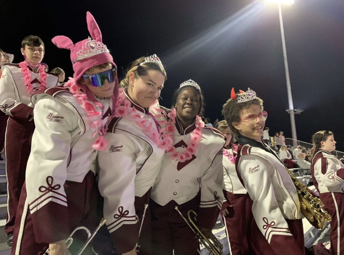 Strike a pose. Aaliyah McGee takes a break from playing to pose with friends during a game. McGee has been chosen as this years 2023 -- 2024 Drum Major. 