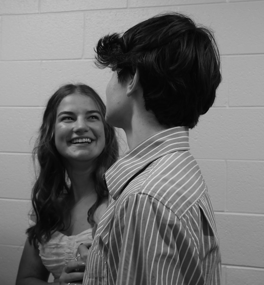 Moment in time. Seniors Claire Piper and Ethan Eisenhart converse before being introduced at the Homecoming dance. Piper was the Homecoming candidate for Chorus. Eisenhart was her escort. 