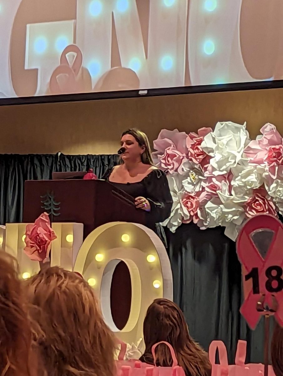 Speaking+to+make+a+change.+Meghan+Stewart+gives+a+heartfelt+speech+on+Oct.+25+at+the+Girls+Night+Out+banquet.+Stewart+shared+her+story+on+overcoming+cancer.