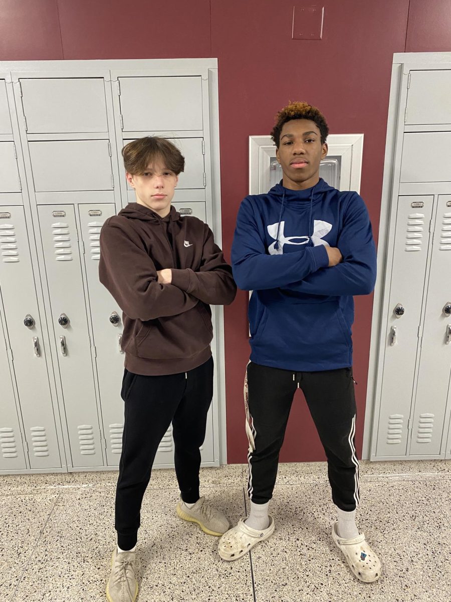 Pose for Success. Junior Imeen Whitaker and Sophomore Braiden Weaver pose in the hall for a picture. These wrestlers both went 5-0 in the duals and made everyone on the team very proud of them.