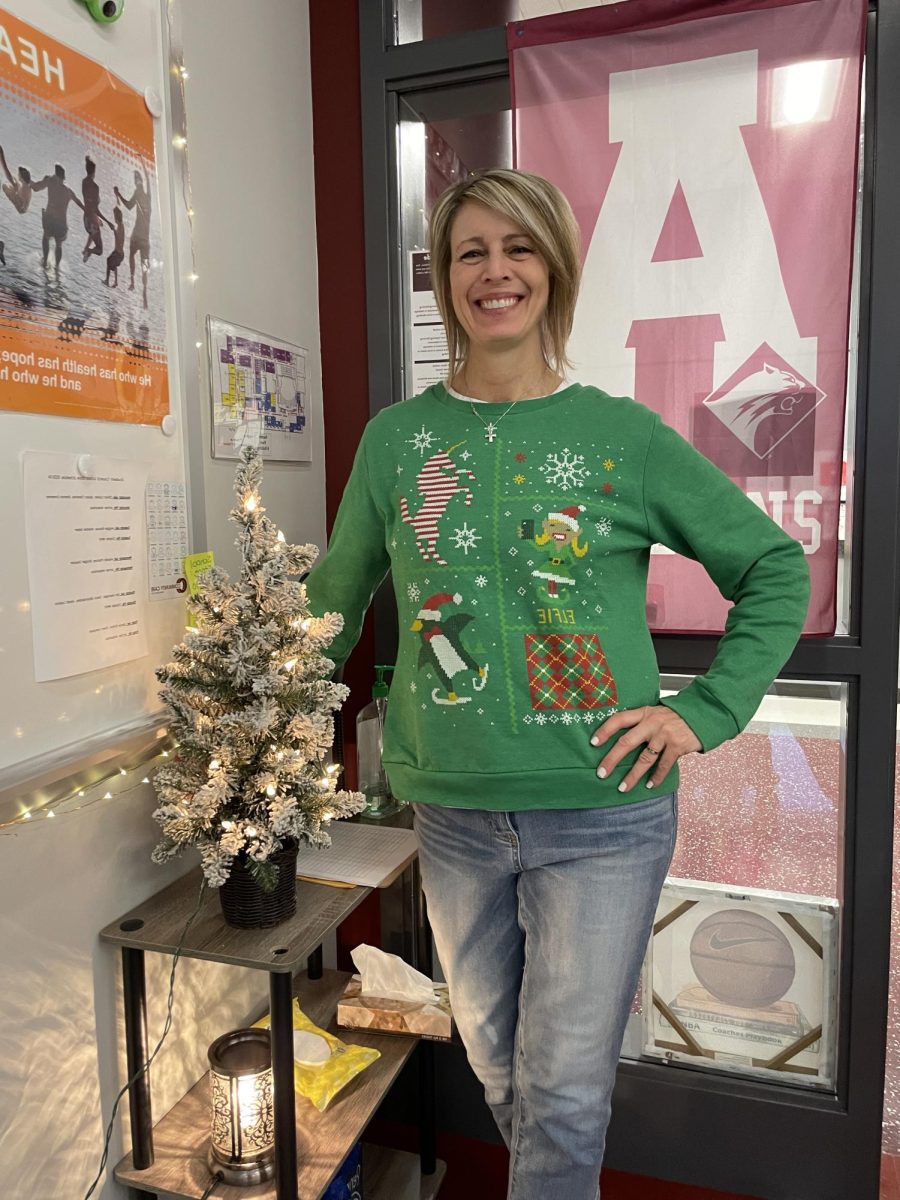 Chistmas cheer. Health teacher and girls basketball coach Amy Palfey shows her holiday spirit with her classroom decorations as well as her wardrobe. Aside from the bright lights and miniature trees, Palfey also plays holiday music in the mornings to celebrate the season. 