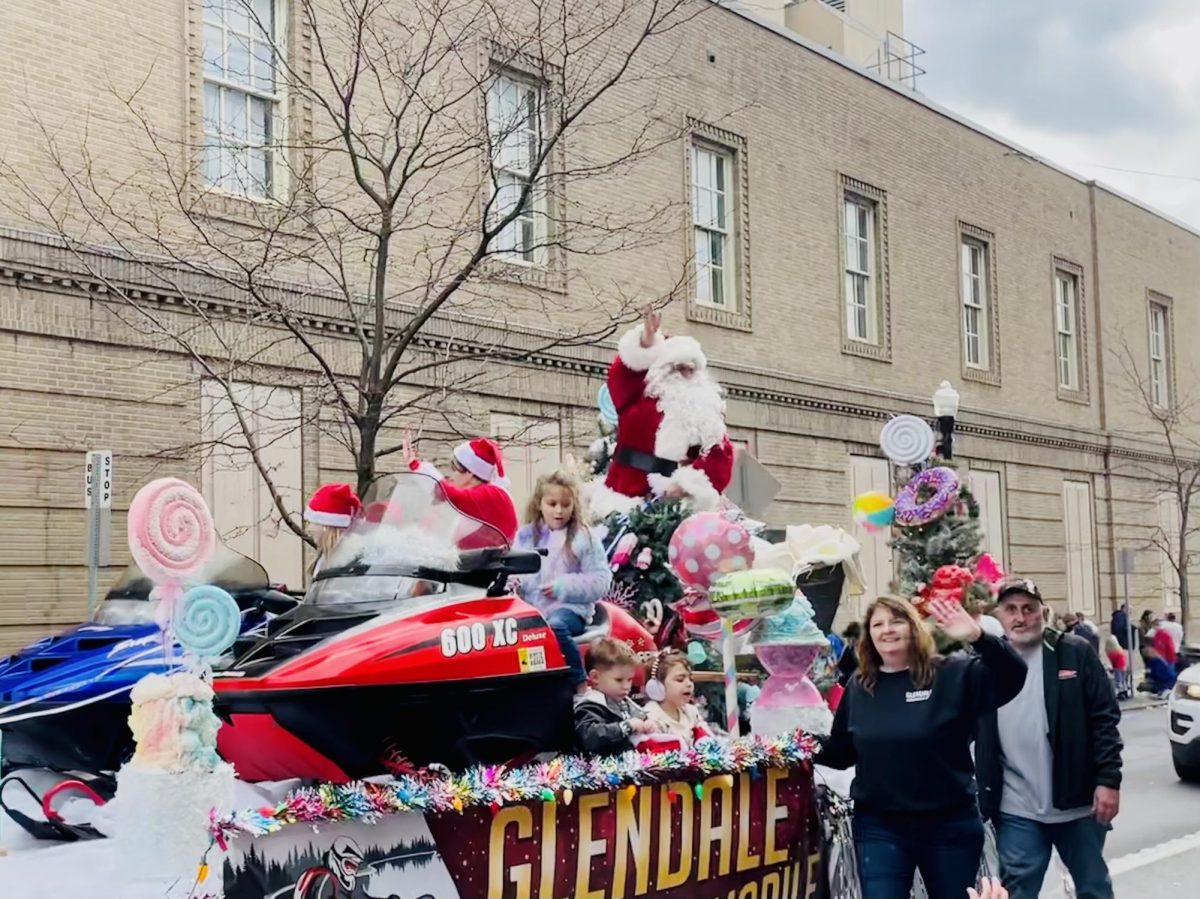 Santa Claus is coming to town! To conclude the Christmas parade on Dec. 2, Santa Claus rode through the streets of downtown Altoona. He rode in on a float from the Glendale Lake Snowmobile Club following many other floats from different organizations throughout Altoona and surrounding areas.  