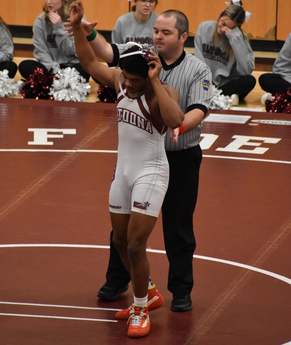 Winning for a Reason. sophomore Ty-Kear Davis gets his hand raised after winning his match 4-0. Davis has wrestled varsity the whole year and has a record of 8-14.