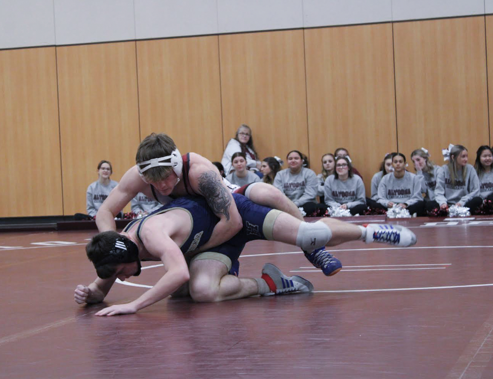 Tightening down the win. Junior Luke Sipes grabs the waist of a Hollidaysburg wrestler. Sipes won  the match against Hollidaysburg leading Altoona to victory. 